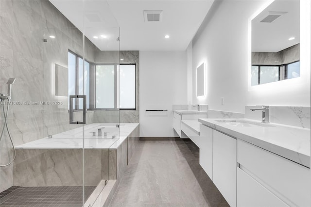 bathroom with vanity and separate shower and tub