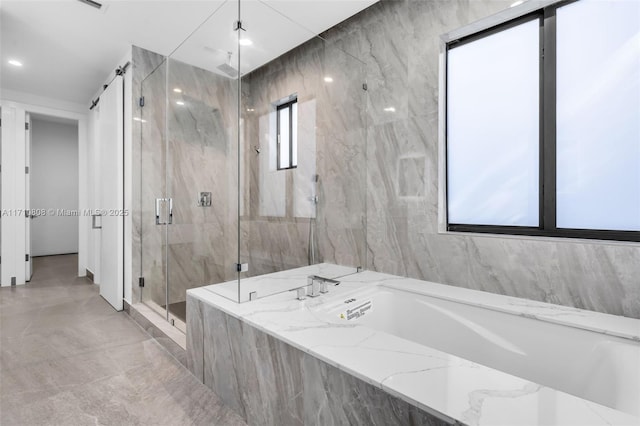 bathroom featuring shower with separate bathtub and a wealth of natural light