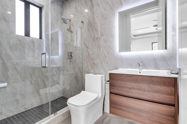 bathroom with walk in shower, vanity, toilet, and tile walls