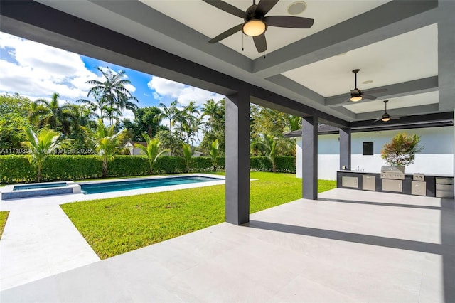 view of patio / terrace with a grill, a fenced in pool, and exterior kitchen