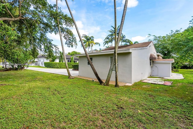 view of side of home with a lawn