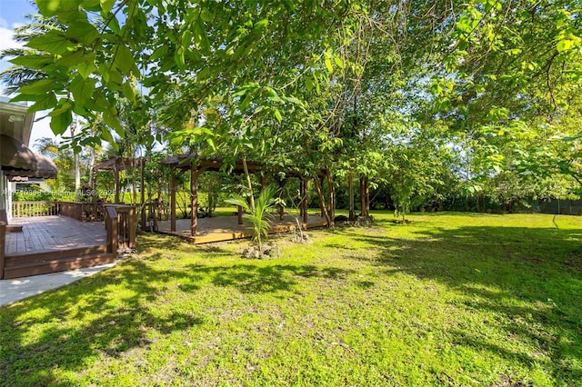 view of yard with a wooden deck and a pergola