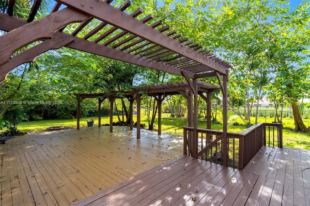 wooden terrace featuring a lawn and a pergola