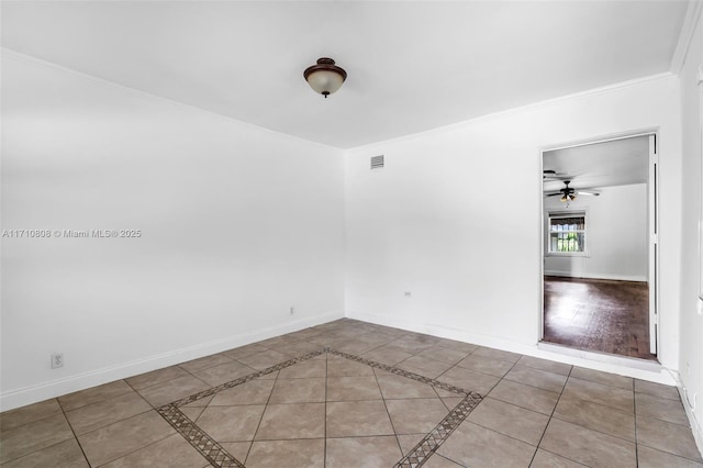 tiled empty room featuring ceiling fan