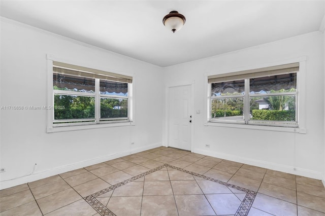 empty room with plenty of natural light and light tile patterned floors