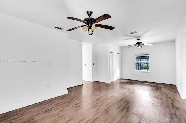 spare room with ceiling fan and dark hardwood / wood-style flooring