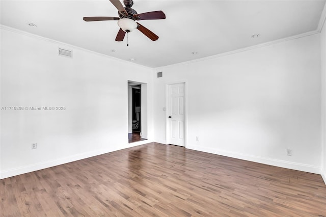 empty room with ceiling fan, ornamental molding, and hardwood / wood-style floors