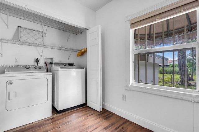 clothes washing area featuring dark hardwood / wood-style floors and washing machine and clothes dryer