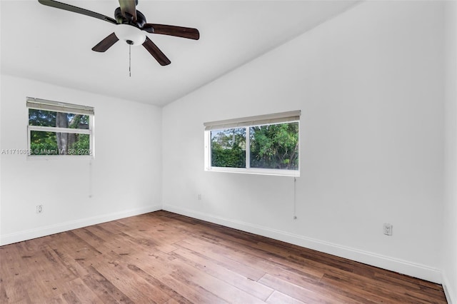 spare room featuring vaulted ceiling, ceiling fan, and hardwood / wood-style floors