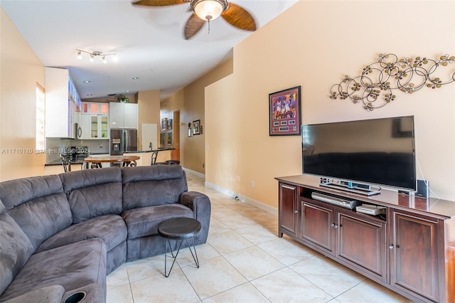 living room with light tile patterned floors and ceiling fan