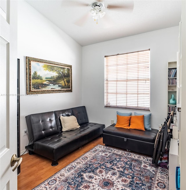 living room featuring wood-type flooring and ceiling fan