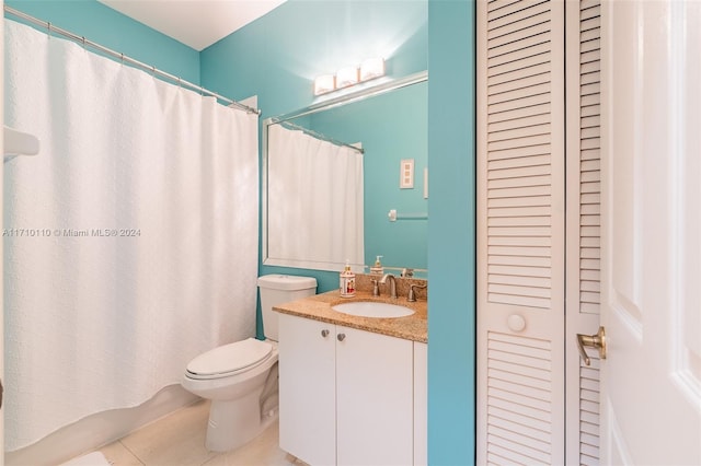 bathroom featuring tile patterned flooring, vanity, and toilet