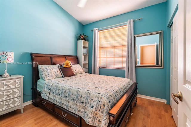 bedroom with ceiling fan and light hardwood / wood-style floors