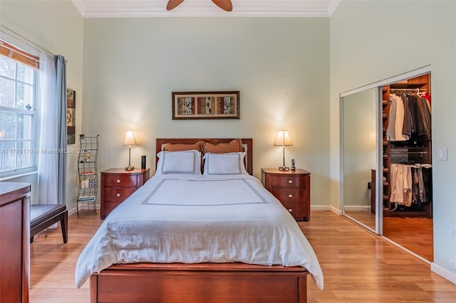 bedroom with a closet, crown molding, ceiling fan, and light hardwood / wood-style floors