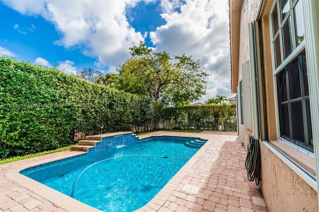 view of swimming pool featuring pool water feature