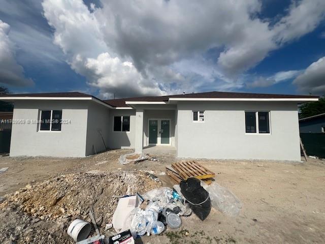 rear view of property featuring french doors