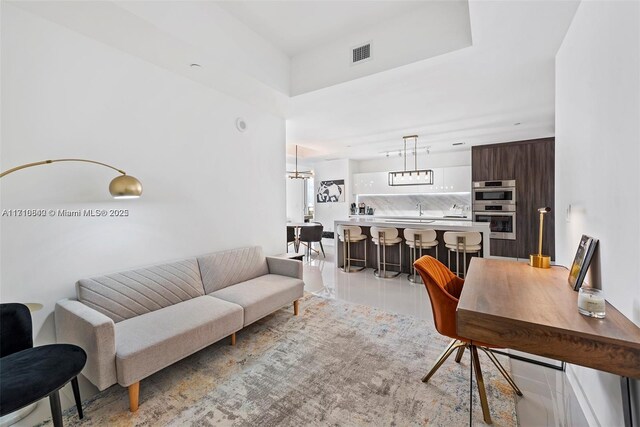 living room with sink and light tile patterned floors