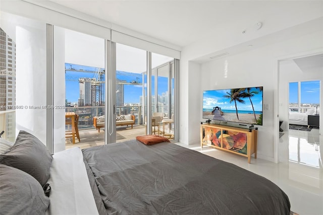 bedroom featuring access to exterior and a wall of windows