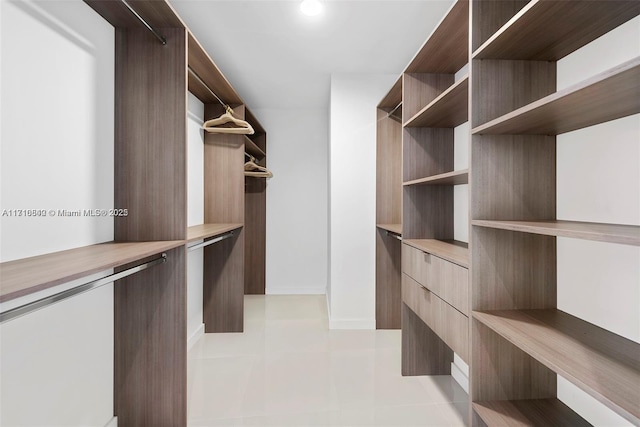 walk in closet featuring light tile patterned floors