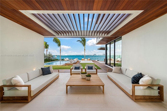 view of patio with an outdoor living space and a water view