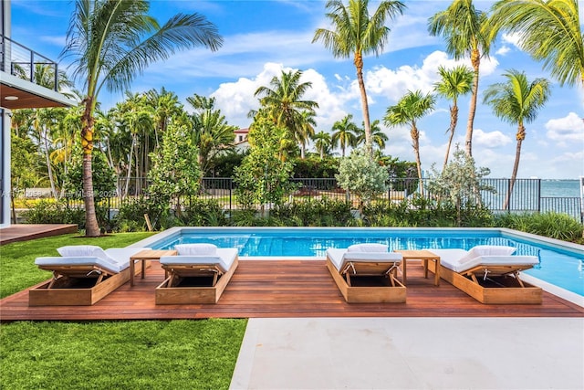 view of swimming pool featuring a yard and a wooden deck