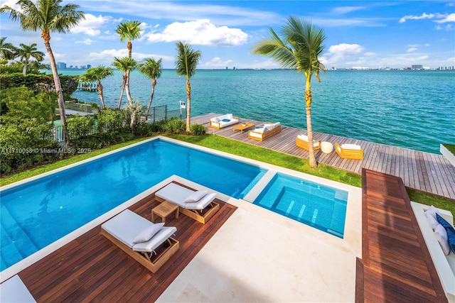 view of pool featuring an in ground hot tub and a water view