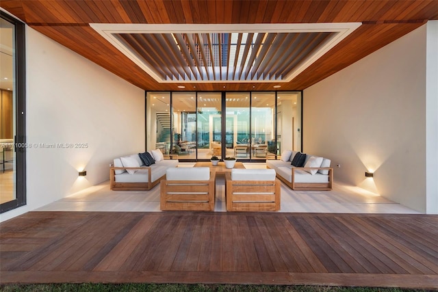 living room with expansive windows and wood ceiling