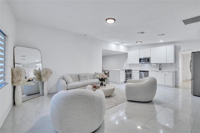 living area featuring marble finish floor, baseboards, and visible vents
