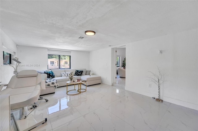 living room with a textured ceiling