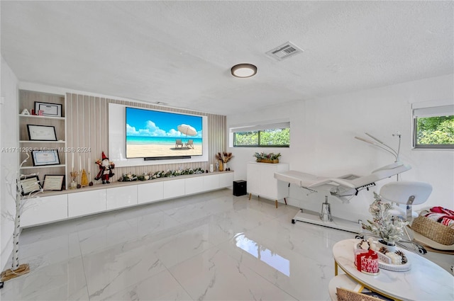 interior space with a textured ceiling