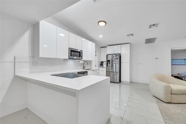 kitchen with marble finish floor, baseboards, visible vents, and stainless steel appliances
