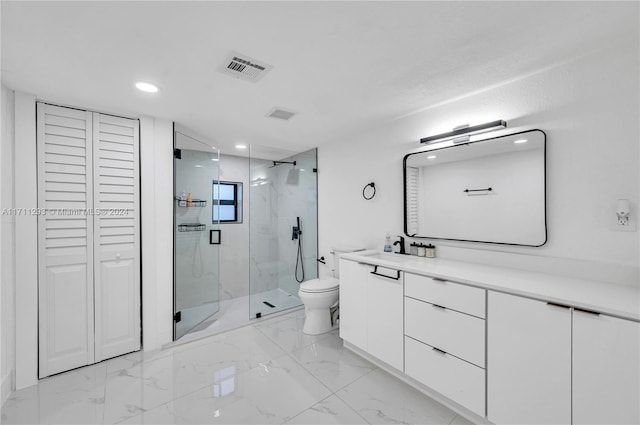 bathroom with a shower with door, vanity, and toilet