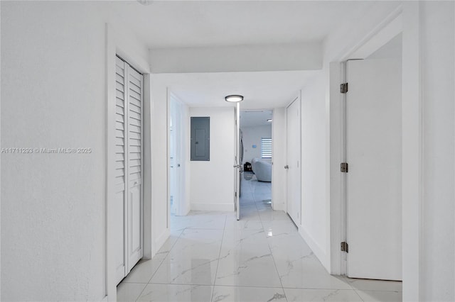 hallway featuring electric panel, marble finish floor, and baseboards