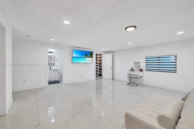 living area with marble finish floor, baseboards, and recessed lighting