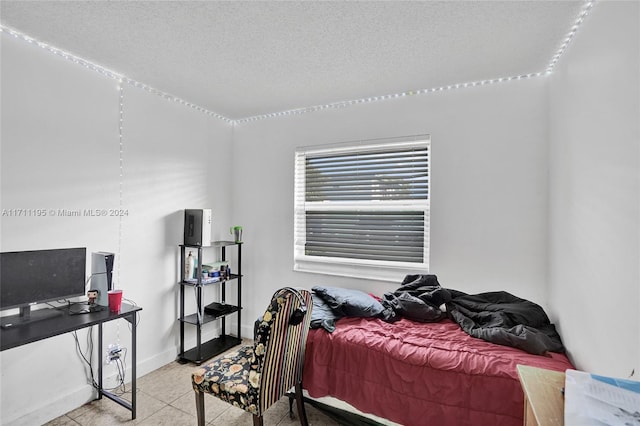 tiled bedroom with a textured ceiling