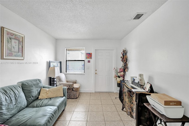 living room with light tile patterned floors and a textured ceiling