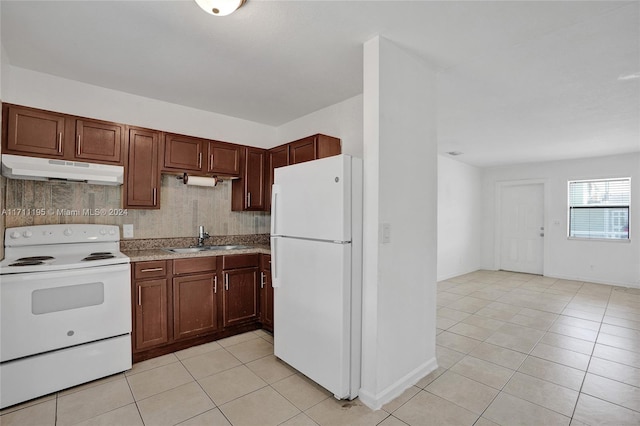 kitchen with backsplash, sink, light tile patterned floors, and white appliances