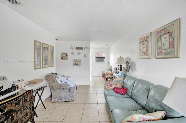 living room featuring light tile patterned floors and a textured ceiling