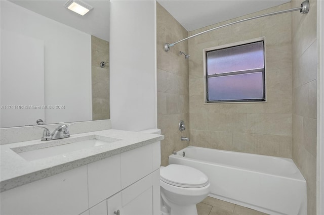 full bathroom with tile patterned flooring, vanity, tiled shower / bath combo, and toilet