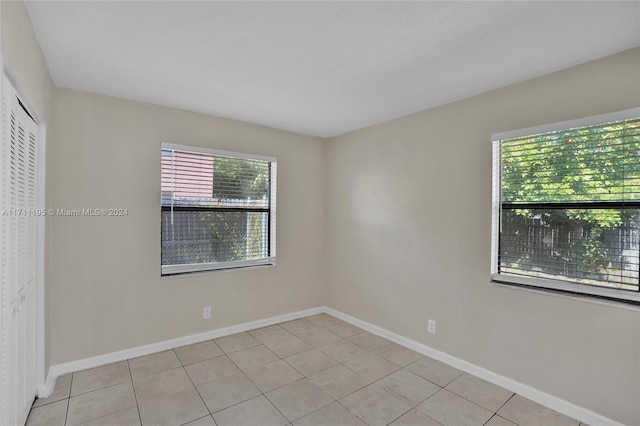 unfurnished room with light tile patterned floors