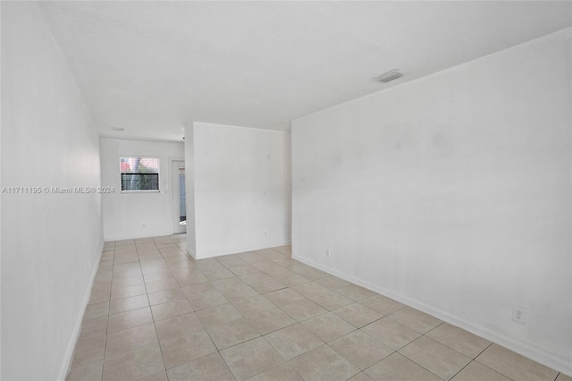 unfurnished room featuring light tile patterned floors