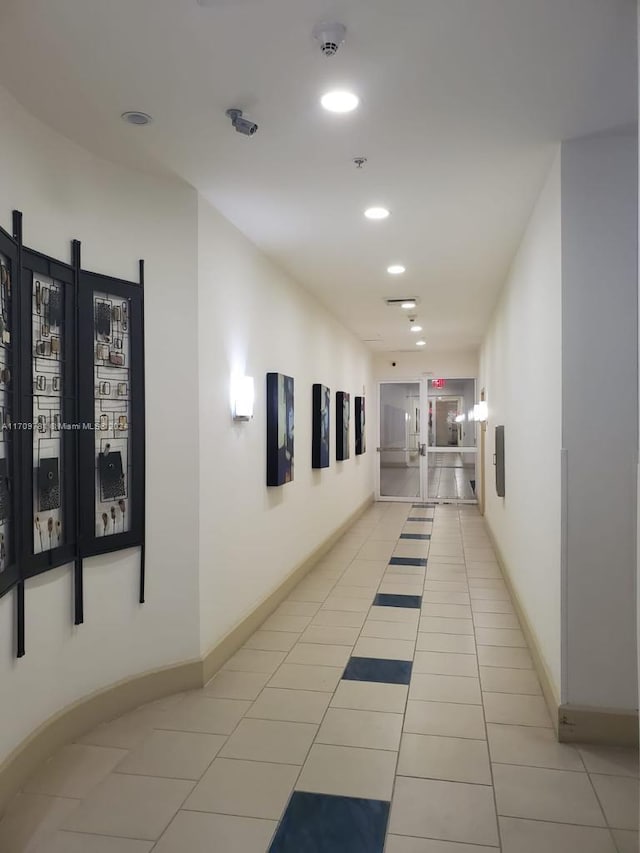 corridor featuring light tile patterned floors