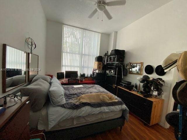 bedroom featuring ceiling fan and dark hardwood / wood-style floors