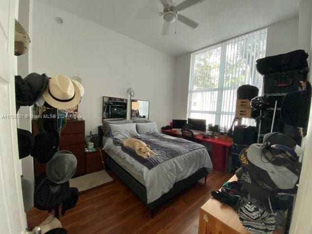 bedroom with ceiling fan and dark hardwood / wood-style floors