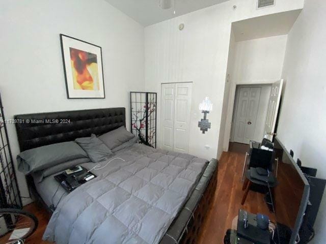 bedroom featuring a closet and dark wood-type flooring