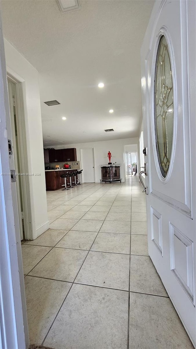 foyer featuring light tile patterned flooring