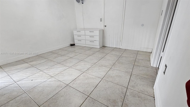 unfurnished bedroom featuring a closet and light tile patterned floors