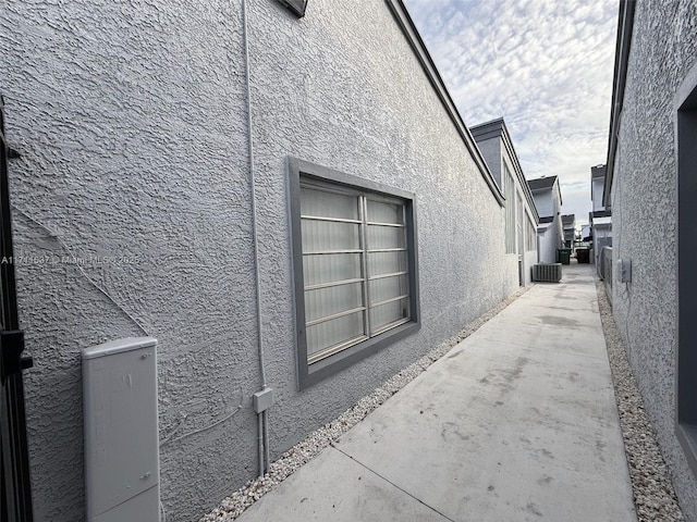 view of property exterior featuring a patio and central AC