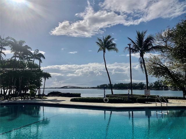 view of swimming pool featuring a water view