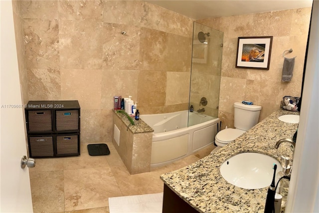 bathroom featuring vanity, toilet, and tile walls